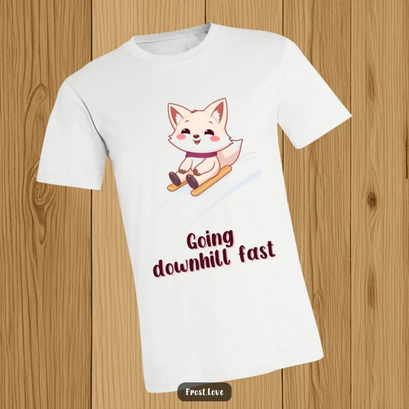 Funny t-shirt showcasing a smiling snow fox character joyfully sliding down a snow-covered hill, radiating excitement and winter playfulness.