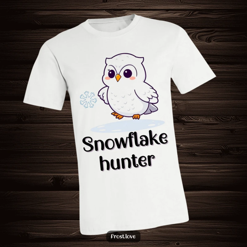 Funny Kawaii snowy owl playfully chasing a snowflake shirt, cute arctic bird fashion, humorous winter wear.
